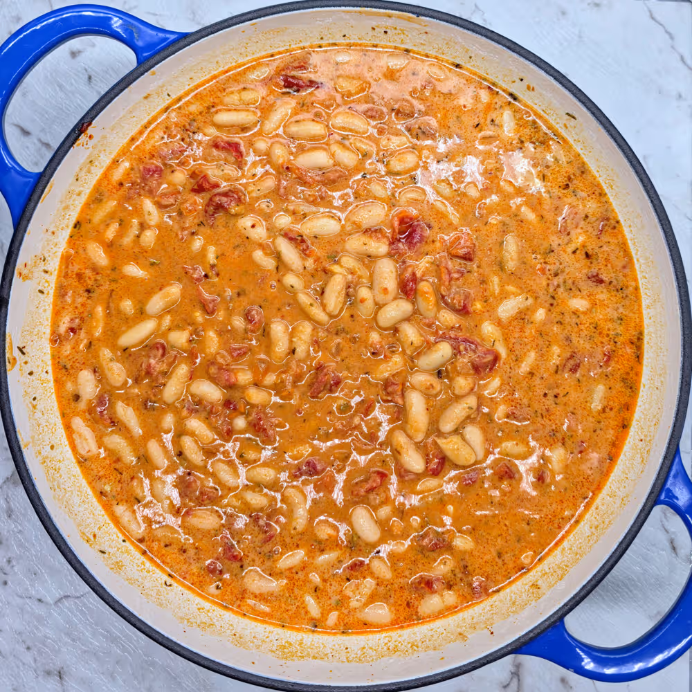  Add the cannellini beans, roughly chopped semi-dried tomatoes, thyme, oregano and prepared white bean sauce. Mix through. 