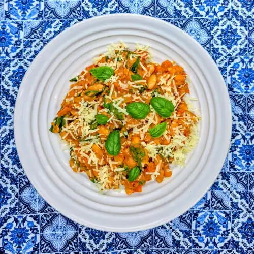  Plated Marry Me Beans garnished with grated parmesan and fresh basil leaves.  